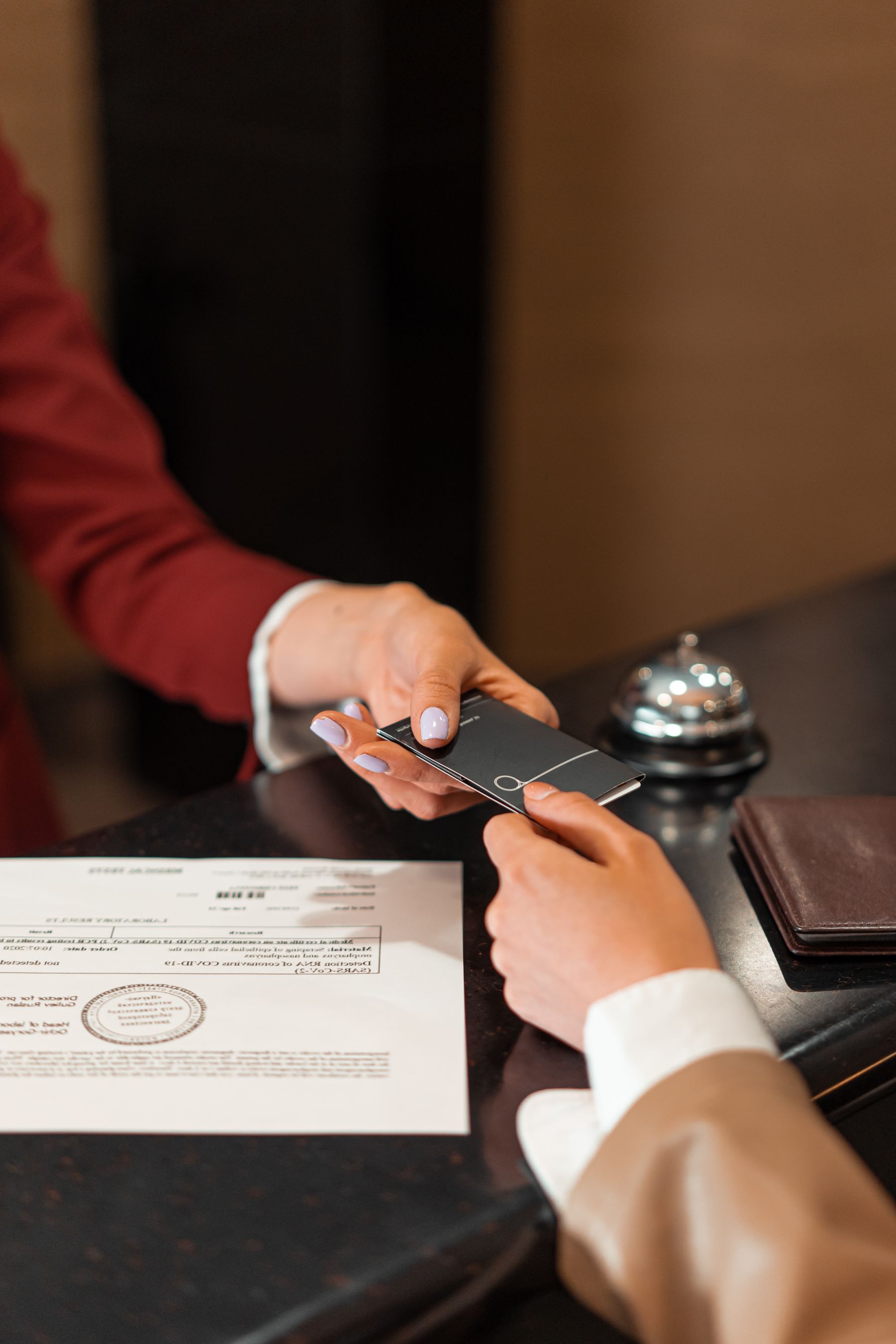 Hotel guest receiving a room key at reception